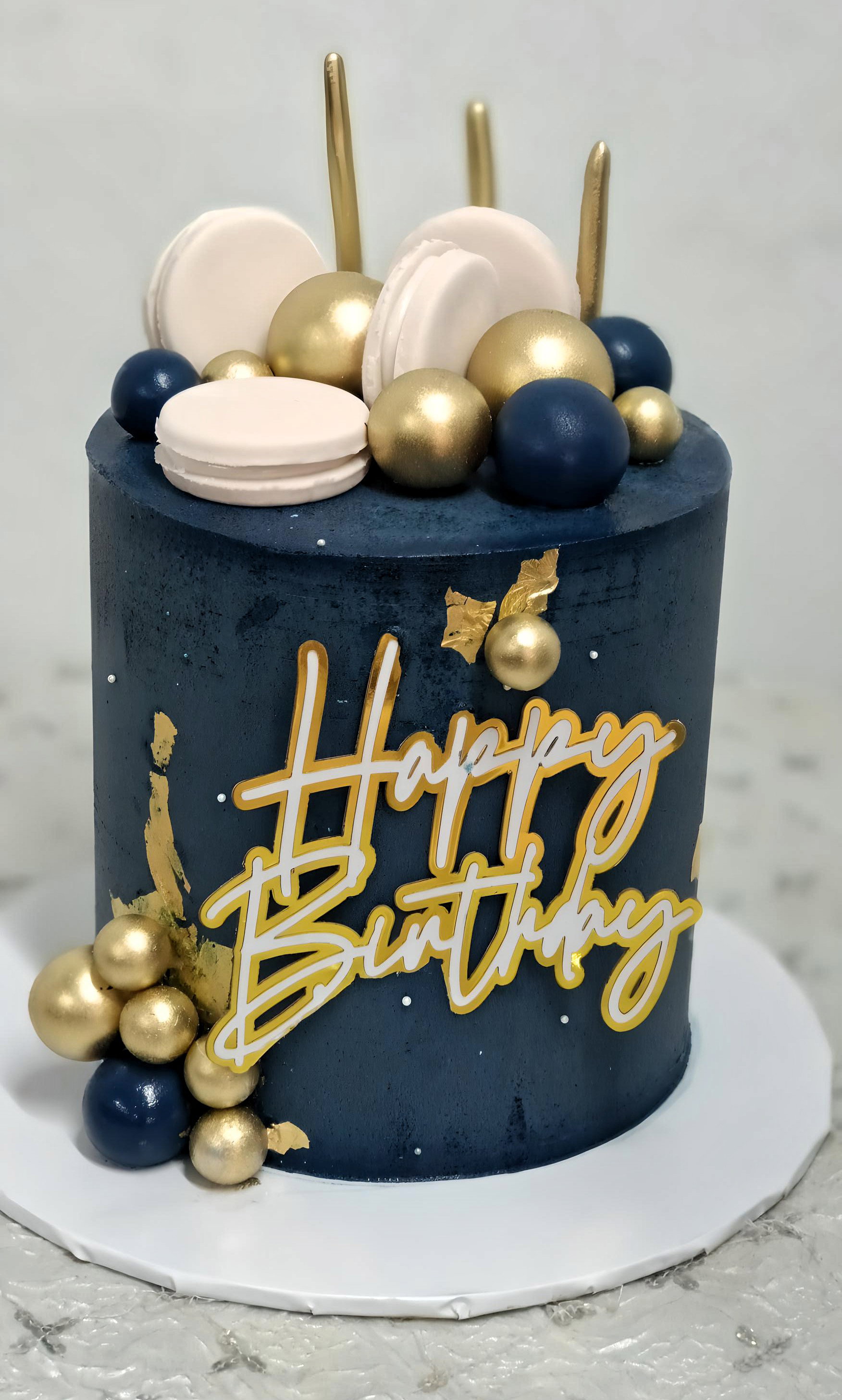 6inches 3 layers blue body decorated with fondant macaroons, balls and hbd topper 