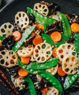 Stirfry Garlic, lotus, green pea, black Fungus, carrot W oyster sauce