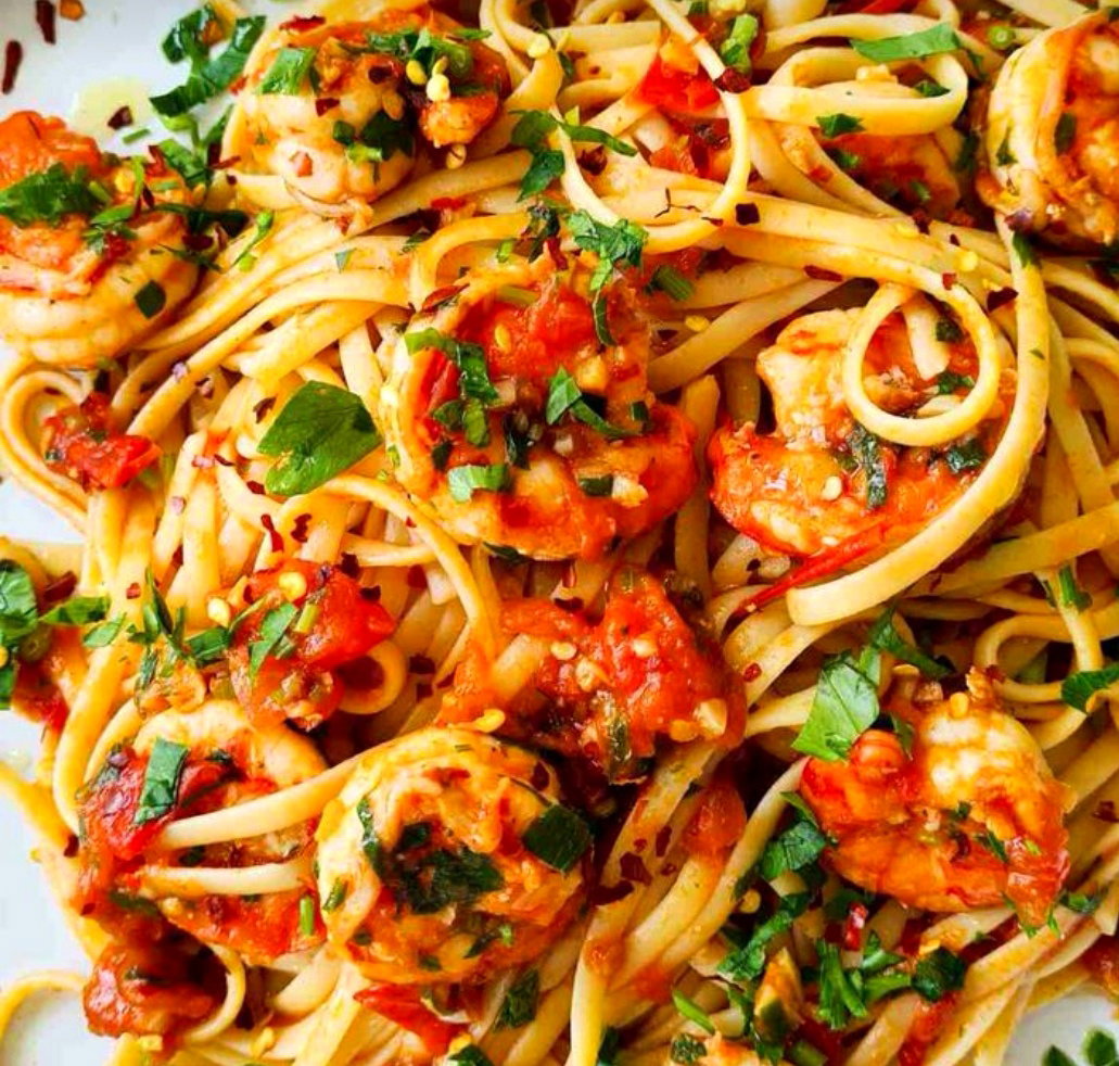 Sautéed Butter garlic prawns W fresh herbs N tomato N Shittake mushrooms fettuccine