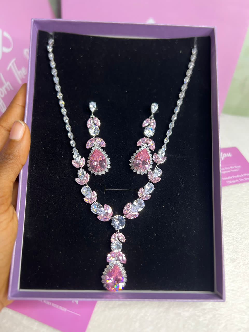 The set features pink and clear stones in a teardrop and oval design_1