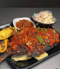 TILAPIA BBQ Platter with potato chips and extra pepper sauce