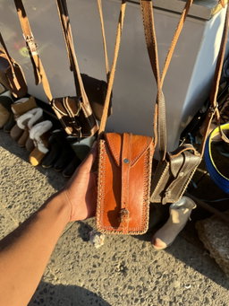 Reddish leather phone case by Ntate Mokete