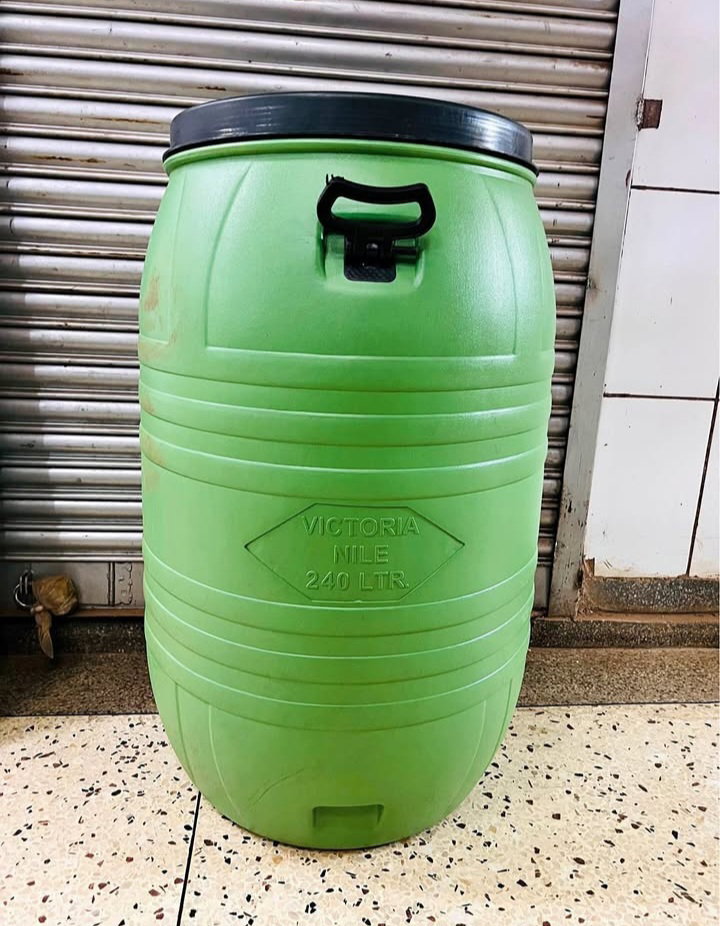 A large, green plastic drum 