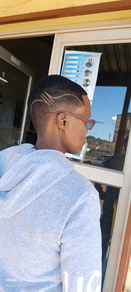 Short Taper Fade with Freestyle Razor Design Lines