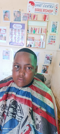 Crisp High Skin Fade with a "Smiley Face" Razor Design