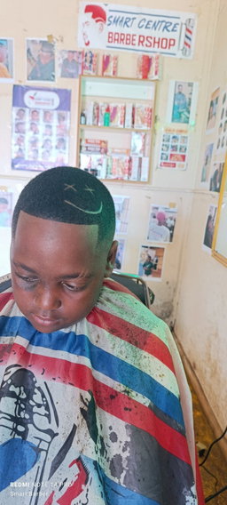 Crisp High Skin Fade with a "Smiley Face" Razor Design