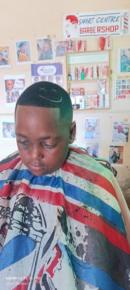 Crisp High Skin Fade with a "Smiley Face" Razor Design