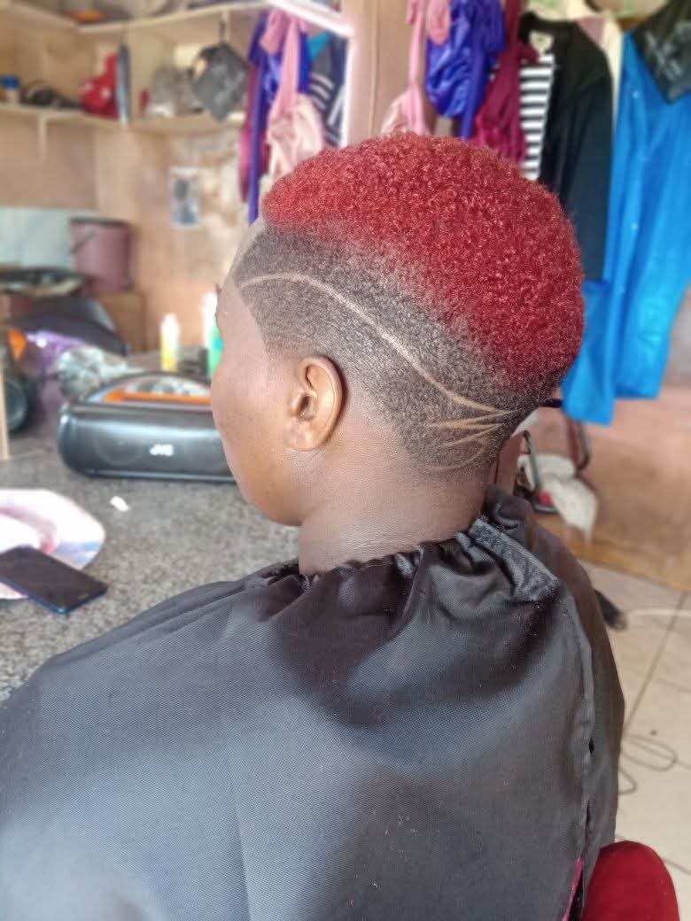 Ruby Red Short Crop with a Taper Fade and Curved Freestyle Razor Art