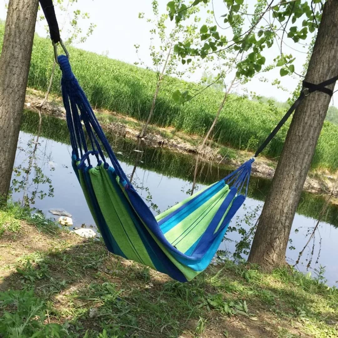 A portable canvas camping hammock slung