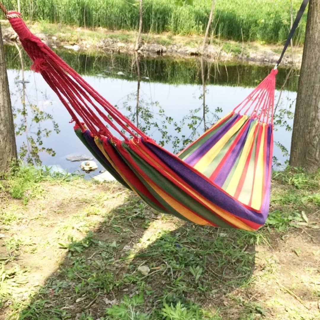 A portable canvas camping hammock slung