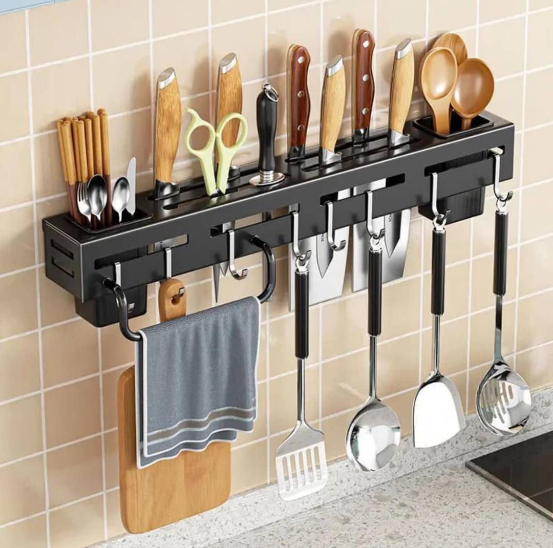 A wall-mounted black metallic kitchen organizer rack