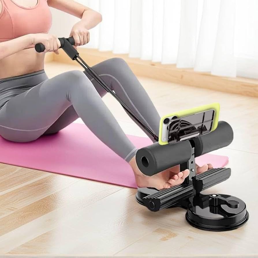 A suction-cup sit-up bar with an integrated resistance band and phone holder