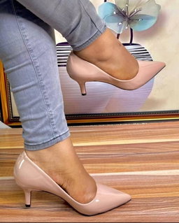 Women's patent leather kitten heel pumps.