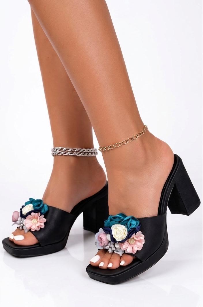 Black slip-on platform mule sandals chunky heel with prominent floral embellishments.
