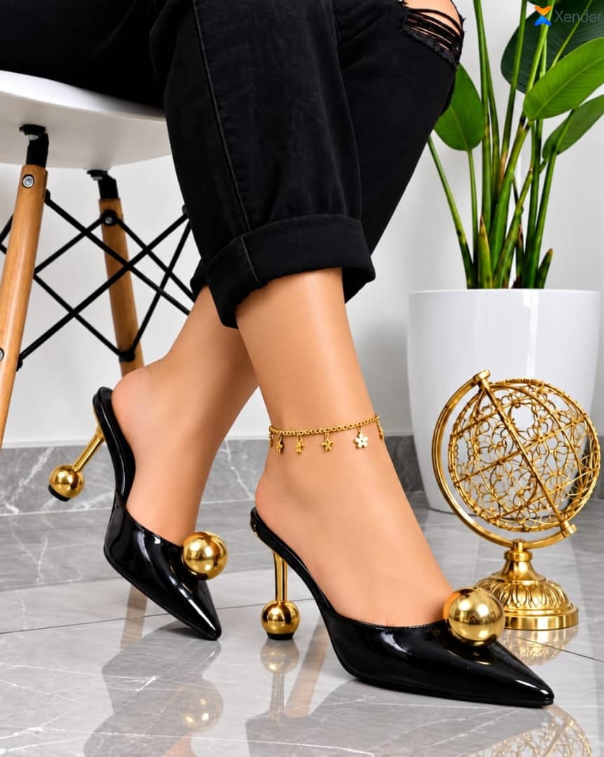 Women's patent leather pointed-toe mule heels dramatic geometric design.