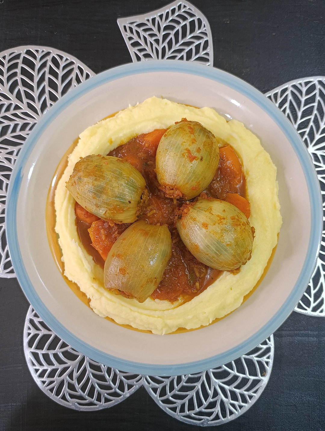 Stuffed onion wraps over creamy mashed potatoes