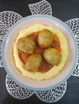 Stuffed onion wraps over creamy mashed potatoes