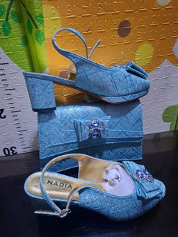 2-piece set featuring mid-heel slingback sandals and a structured clutch purse,